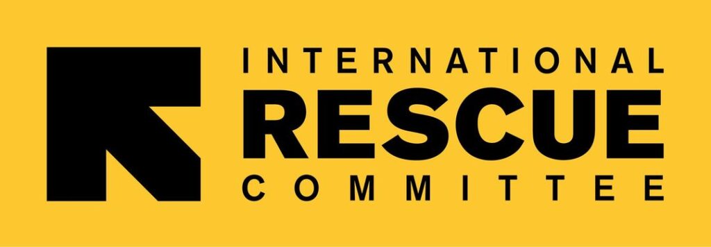 IRC logo on a yellow background featuring a black geometric mark and the text 'INTERNATIONAL RESCUE COMMITTEE'
